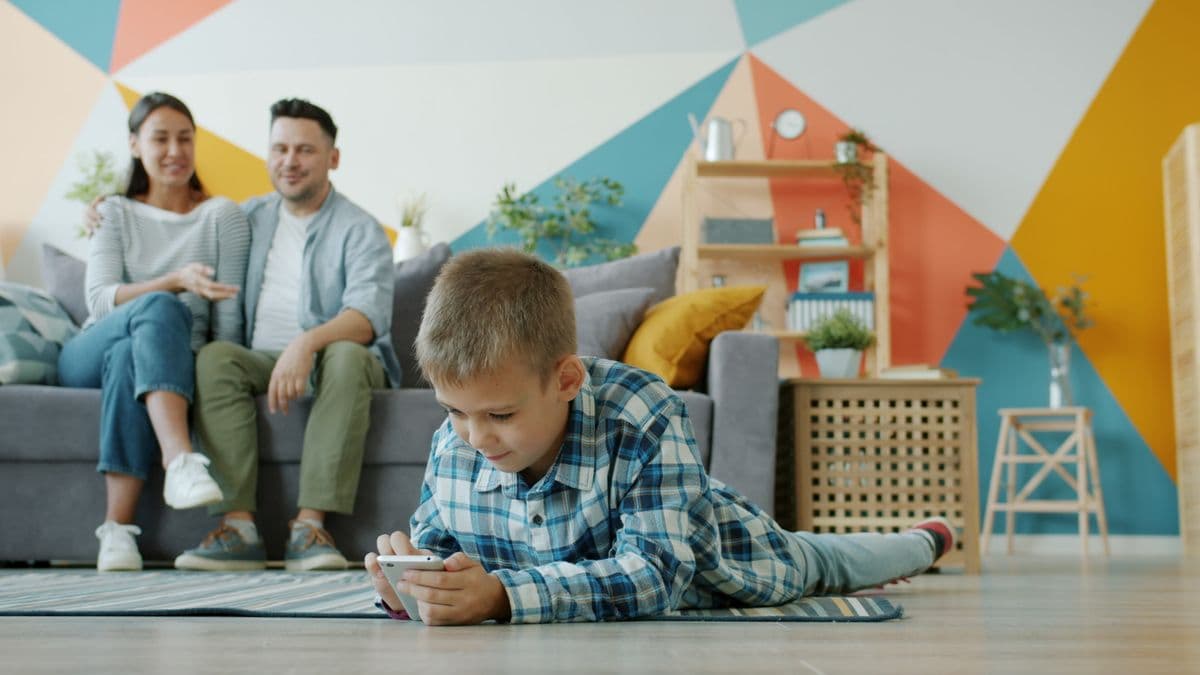 A family relaxed and bonding together in a bright, modern living room
